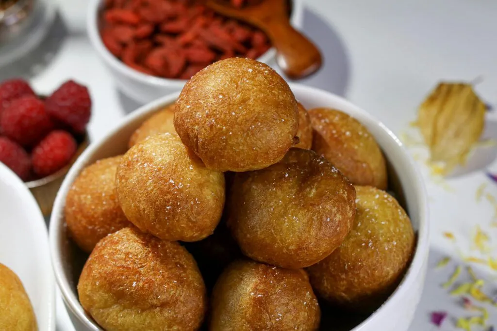 Mouthwatering Nigerian puff puff in a white ceramic bowl, ready to eat.